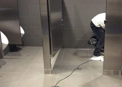 Cleaning a commercial restroom floor-Alex Stone and Tile Services, Los Angele, Ca.
